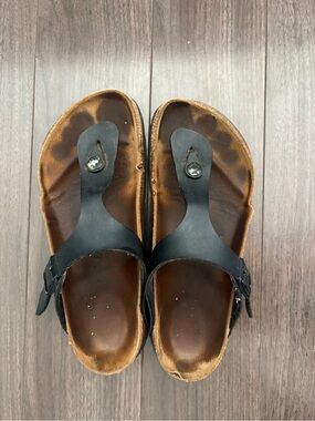 Well worn black leather Birkenstock sandals